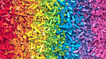 Lot of colorful rainbow toy bricks background. Educational toys for children. 3D Rendering